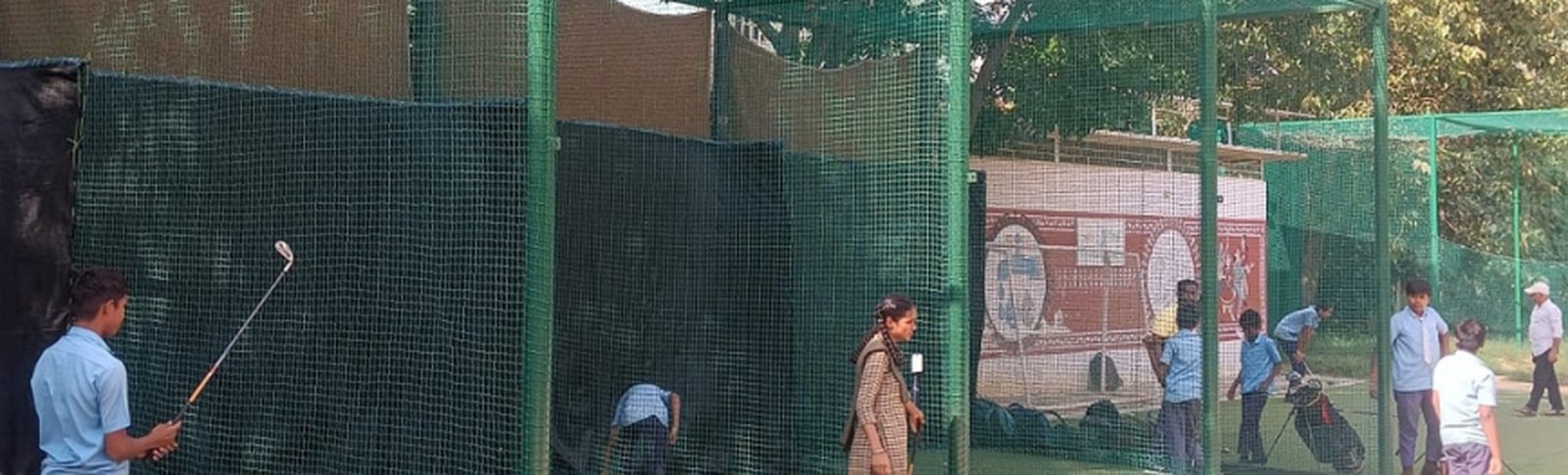 Children practising golf inside a net at Begur Government School